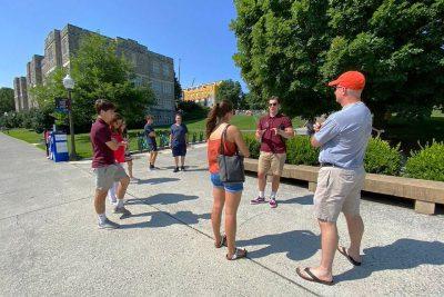 Several people stand outside on a campus tour